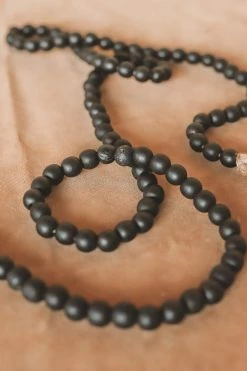 CREATIVE CO OP DISTRESSED BLACK PAULOWNIA WOOD GARLAND · 72