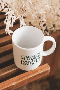 ACME STUDIOS SOMEBODY IN ND LOVES ME MUG