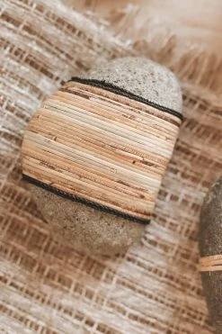 CREATIVE CO OP RATTAN-WRAPPED RIVER STONE DECOR