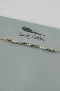 LUCKY FEATHER MORSE CODE NECKLACE · BRAVE