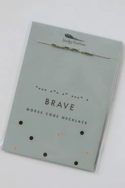 LUCKY FEATHER MORSE CODE NECKLACE · BRAVE