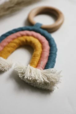 CHEWABLE CHARM RAINBOW MACRAME TEETHER · TEAL + ROSE